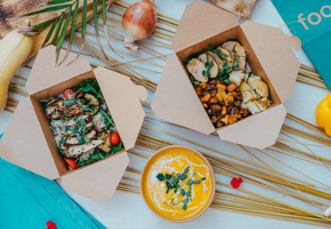 Eco-friendly food packaging with healthy meals in bamboo containers