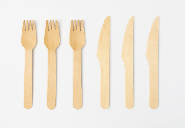 Eco-friendly bamboo forks and knives set on a white background