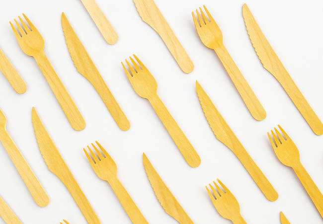 Arrangement of bamboo forks and knives on a white background
