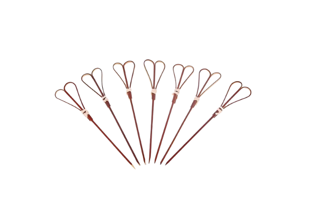 Brown double-loop bamboo knot skewers neatly arranged on a white background.