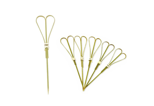 Decorative double-loop bamboo knot skewers arranged on a white background.