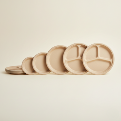 Side lineup of bamboo fiber plates showing multiple diameters, including 3-compartment plates, designed for bulk wholesale programs.